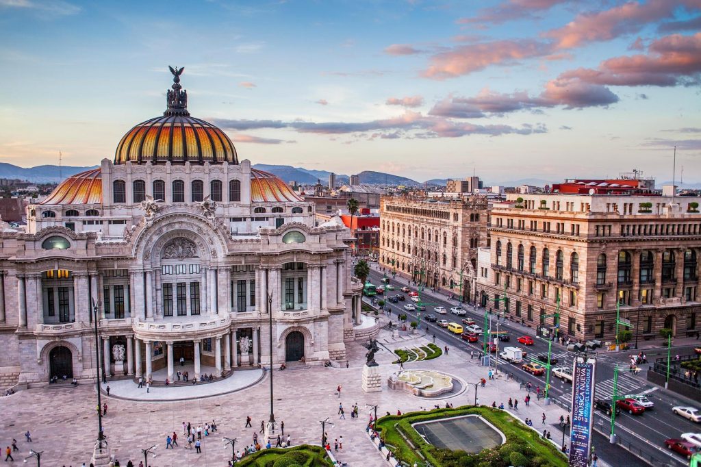 The busy streets buzzing with travelling cars & people of Mexico City