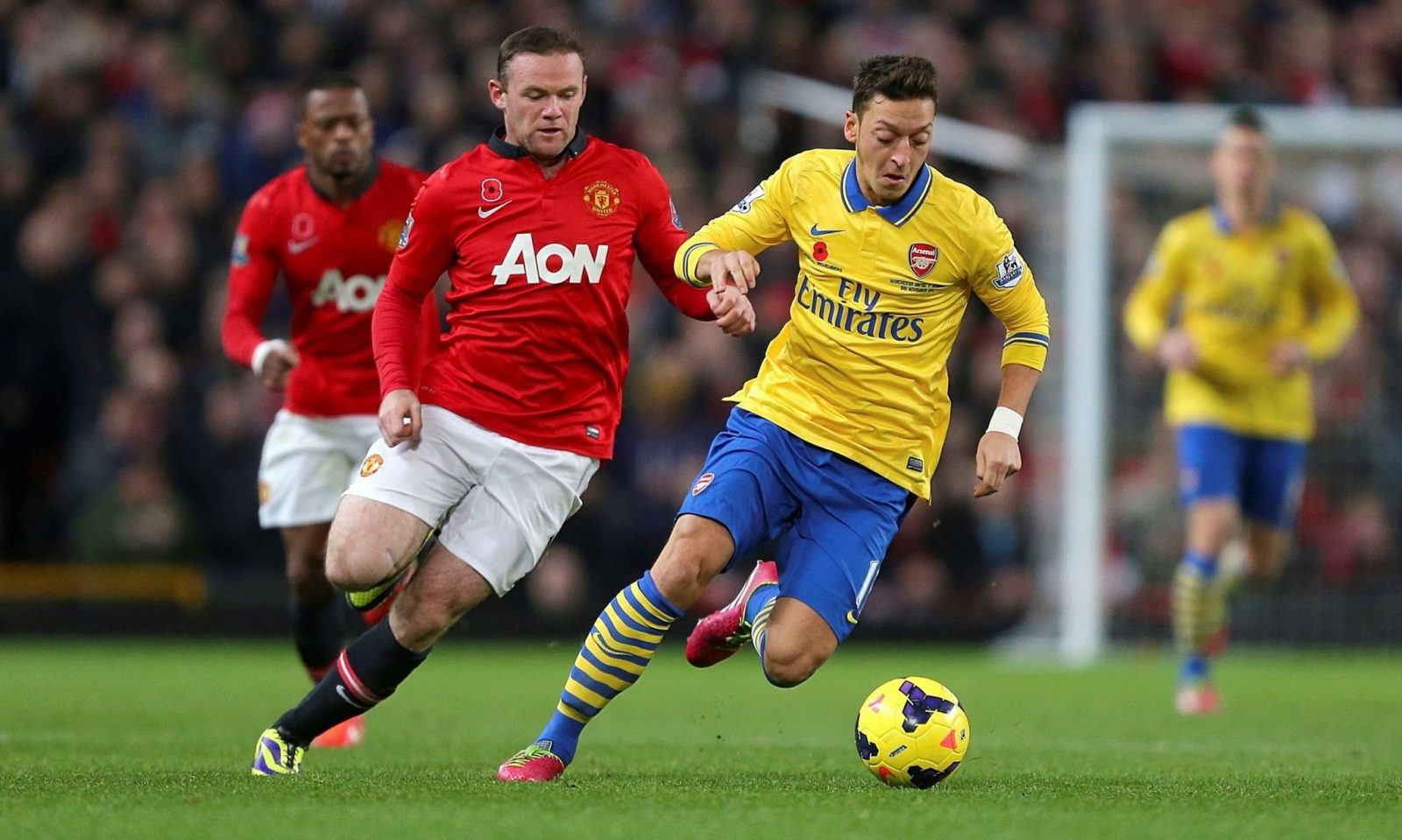 Wayne Rooney vs Mesut Ozil playing football, one of the most popular sports in 2021