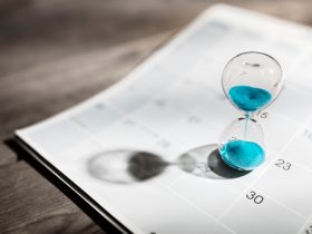 Hour glass on calendar concept for time slipping away for important appointment date, schedule and deadline